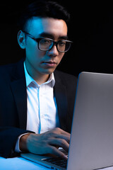 Portrait of Asian male programmer working at night