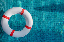Top View Of Lifebuoy Floating On Top Blue Water