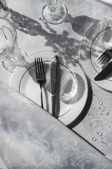 details of table setting in light colors. canteens pibors on the table.