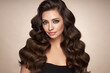 © Oleg Gekman - Brunette girl with perfect makeup. Smiling beautiful model woman with long curly hairstyle. Care and beauty hair products.