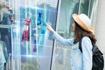 futuristic technology,smart retail online concept.Woman try to use  hologram display with virtual augmented reality in the shop or retail to choose select ,buy cloths and change a color of products