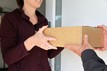 Woman receiving a package from a currier