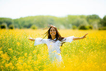 Young woman in the rapeseed field