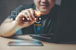 © Aon Khanisorn - Customer service, Young Asian Businessman give a happy smile and five star shape on a virtual digital screen with smartphone and laptop, the concept of surveying rating satisfaction.