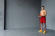 © Drobot Dean - Young shirtless sportsman doing exercise with expander stretch tape