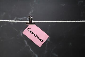 the concept of commitment by hanging paper on a rope. Selective focus