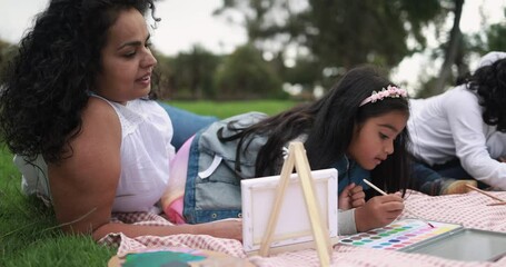 Poster - Happy indian parents having fun at city park painting with their children - Family, summer and love concept 