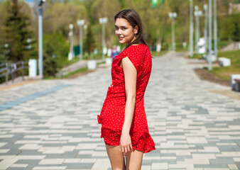 Back view portrait, young slender woman in red dress