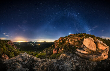 Wall Mural - Panoramic of the winter milky way with the constellations of the zodiac, orion, pleiades, taurus. Night landscape of a valley of rocks and the arch of the Milky Way. El Garbi, Valencia Spain