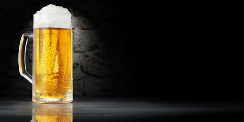 Wall Mural - Cold beer on desk and dark background with shadows. 