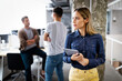 © NDABCREATIVITY - Beautiful business woman holding tablet computer in office