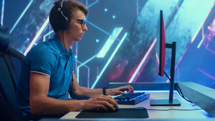 Wall Mural - Professional eSports Gamer Plays RPG MOBA Mock-up Video Game with Super Action and Fun Special Effects on His Personal Computer, Celebrates Victory over Round Winning. Cyber Gaming.