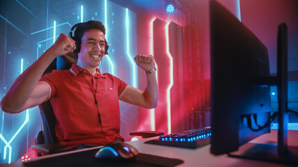 Wall Mural - Professional eSports Gamer Playing in Computer Video Games, Happily and Cheerfully Celebrates Victory and Success. Online Cyber Championship / Tournament. Portrait Semi-Side View