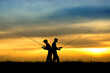 © Mihai - Silhouette of fishermen in sunset.