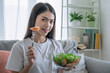 © Basicdog - Asian young woman eating vegetable salad, Eating good food for good health, Organic Salad.