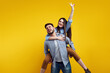 © Davidovici - Happy couple have fun together, man gives piggyback ride to female