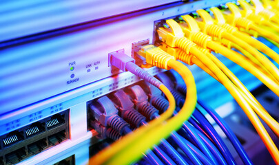 Fiber Optical cables connected to an optic ports and Network cables connected to ethernet ports