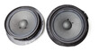 Pair of speakers of an acoustic system - an audio for playing music in a car interior on a white isolated background in a photo studio. Spare parts for auto repair in a workshop or for sale for tuning