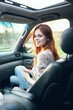 © SHOTPRIME STUDIO - woman fellow traveler in a car salon in the front seat design open window nature