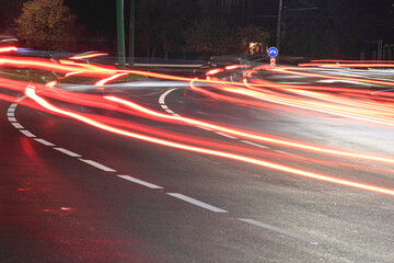 The junction of two roads, light traces from the car. The picture was taken at night at a slow shutter speed