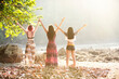 © Chaiphorn - Three young women happily raise their hands in summer day lifestyle relax and chill outdoors near at the sea. Vacations in Summer Tropical Beach Concept.