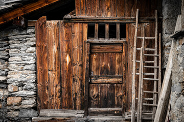 View of the wooden door of a shed in the Italian alps