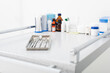 © LIGHTFIELD STUDIOS - medicines and clean dental metal tools in tray on medical table.