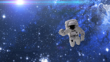 Wall Mural - cosmonaut fly in the outer space with stars and galaxy background with a light beam. elements of thi