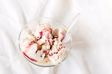 Wall Mural - Vanilla ice cream with chocolate chip cookies, chocolate chips and caramel, strawberry or raspberry sauce.