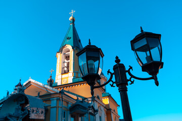 Wall Mural - Street lamp in front of the church  . Cupola and street light 