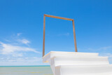 Fototapeta Dziecięca - Ladder with steps to the wooden frame in front of clear and beautiful scenic view of blue sea and clear sky with horizon in tropical island shows art concept for path of success to heaven door.