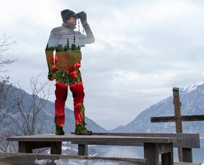 man looking with binoculars the spring in a winter landscape