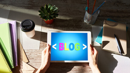 Wall Mural - tablet with blog text the on screen. social network, communication and internet marketing concept.