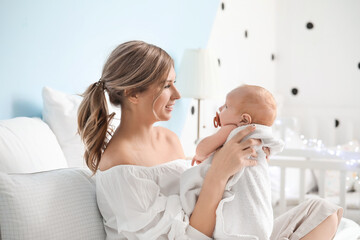 Sticker - Happy mother and cute little baby on bed at home