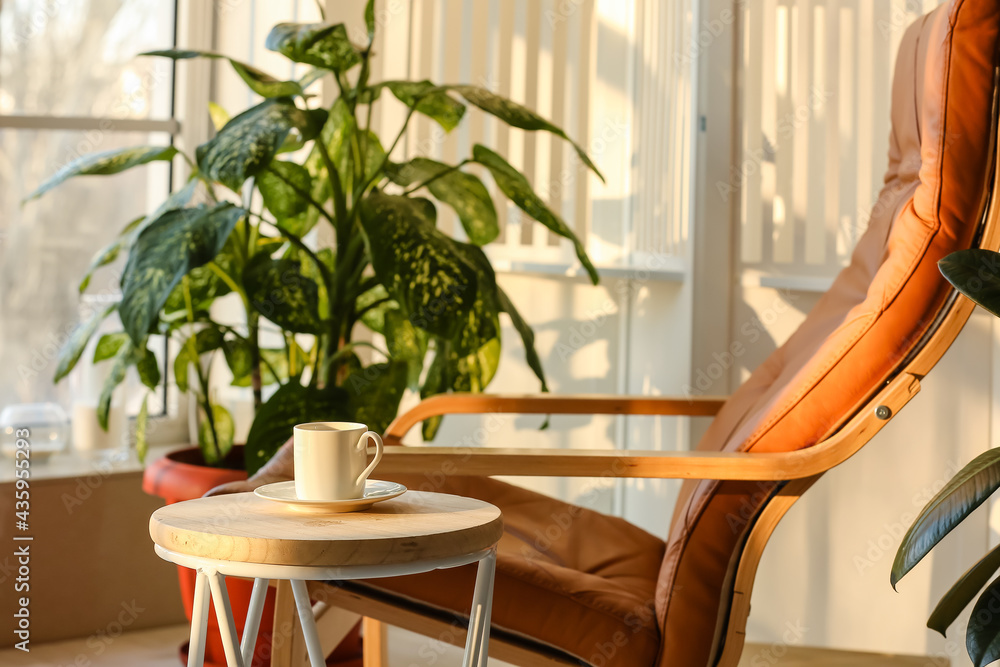 Cup of coffee on table in modern room