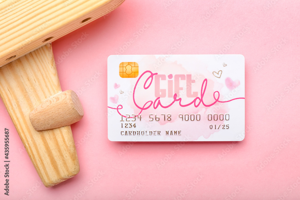 Gift card and wooden plane on color background, closeup