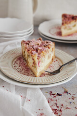 Canvas Print - Closeup shot of delicious rhubarb cheese pie on a plate on a white table