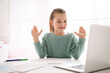 © New Africa - Little girl learning English indoors at online lesson