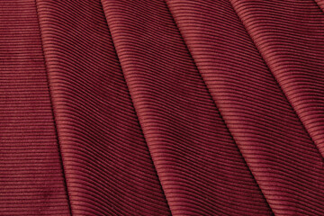 Wall Mural - Close-up texture of natural red or burgundy fabric or cloth in same color. Fabric texture of natural cotton, silk or wool, or linen textile material. Red and orange canvas background.