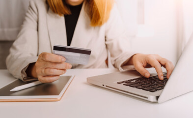 male hands holding a credit card and use mobile phone for Online payment online shopping