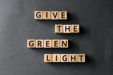 Wall Mural - Ggive the green light - phrase from wooden blocks with letters, the go-ahead concept, gray background
