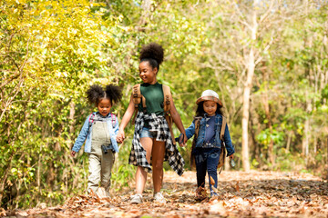 Group family children checking map for explore and find directions in the camping jungle nature and adventure. Tourism kids travel for destination and leisure trips for education