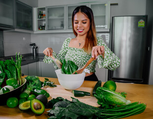 Asian girl cooking healthy vegetarian and vegan food, vegetables and fruits in the kitchen, healthy lifestyle