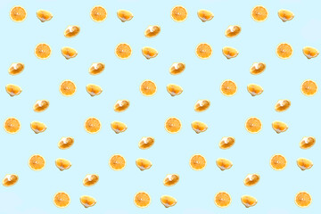 Wall Mural - Bright colorful repetitive pattern made of lemon pieces on blue background. Minimal abstract concept flatlay .