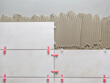 © wabeno - Ceramic wall tile in position over adhesive with lash tile leveling system