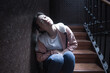 young beautiful Asian woman in pain suffering depression - dramatic indoors portrait on staircase of sad and depressed Korean girl as victim of bullying and abuse