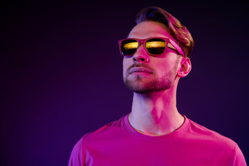 Sticker - Portrait of attractive serious successful guy wearing specs looking far away isolated over dark neon purple color background