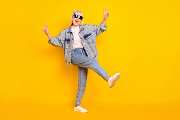 Sticker - Full length body size view of elderly retired pensioner trendy cheerful woman showing v-sign dancing isolated over bright yellow color background