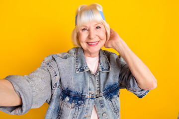 Sticker - Photo portrait of senior woman smiling taking selfie in stylish clothes isolated on bright yellow color background