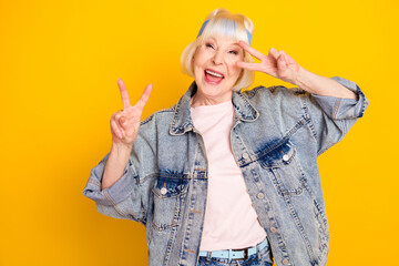 Poster - Portrait of attractive overjoyed cheerful woman having fun showing v-sign fooling isolated over bright yellow color background